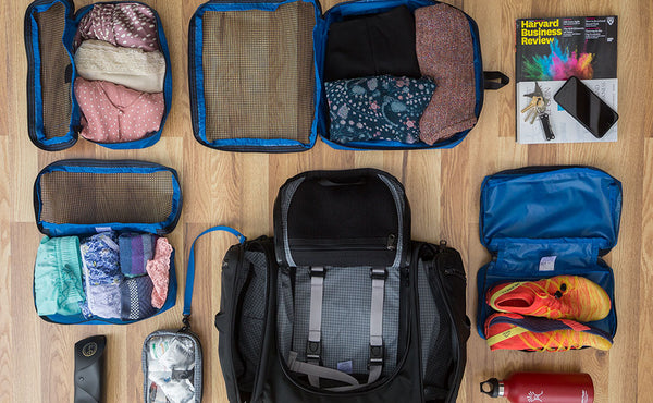 An example of a typical Aeronaut 30 loadout is one Large Packing Cube, two Small Packing Cubes, a book, one End Pocket Packing Cube, a 3D Clear Organizer Cube, a reuseable water bottle, and eyeglasses.